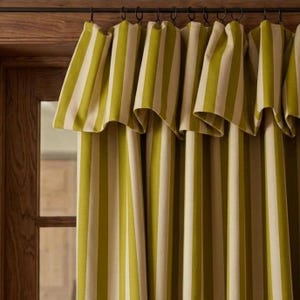 Olive green striped blackout curtains made from cotton linen blend fabric with vertical woven stripes. Cotton lined farmhouse style drapes offering privacy, thermal insulation, and light blocking. Cottagecore and rustic home decor window curtains suitable for bedroom, living room, nursery, and cozy interiors.
