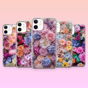 May include: Five smartphone cases arranged in a row, each featuring a distinct, vibrant floral pattern. The designs display a dense collection of roses, hydrangeas, and various small blossoms in shades of pink, blue, yellow, and purple.