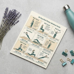 May include: A flat lay featuring a 28-Day Wall Pilates Workout Guide, a teal water bottle, a bundle of lavender, and teal binder clips. The workout guide displays illustrations of various Pilates exercises.