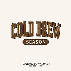 May include: A digital graphic design featuring the words "COLD BREW" in a brown, arched, collegiate-style font above the word "SEASON" in a smaller, oval-shaped brown font. The background is a light beige color.