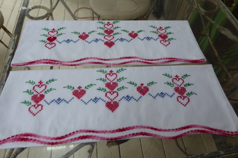 Vtg Hand Embroidered Pr White Cotton Pillowcases wCrochet Edge Red Hearts Green Leaves Blue Cross Stitch Standard Sz