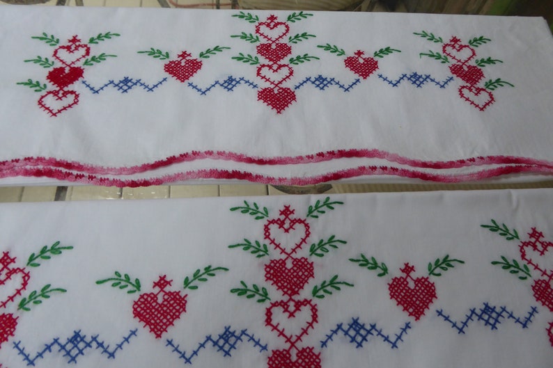 Vtg Hand Embroidered Pr White Cotton Pillowcases wCrochet Edge Red Hearts Green Leaves Blue Cross Stitch Standard Sz