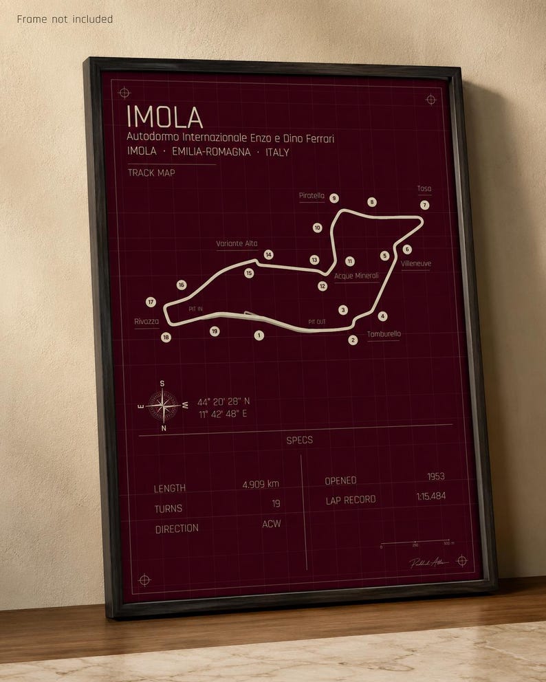 May include: Framed track map of the Imola circuit in Italy, with a burgundy background and white track lines. The map includes the track's length of 4.909 km, 19 turns, and the year it opened, 1953. The frame is black.