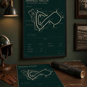 May include: A framed Brands Hatch track map print in a dark green color. The print includes track details, specs, and the text "Brands Hatch West Kingsdown - Kent - England". A rolled print and a helmet are also visible.