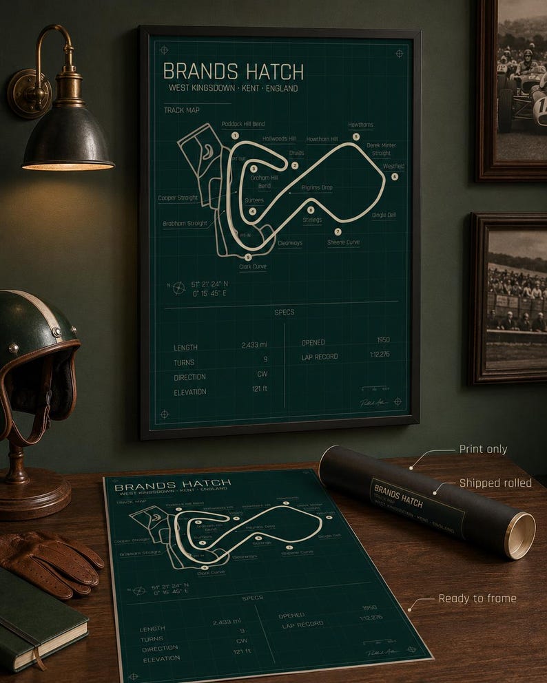 May include: A framed Brands Hatch track map print in a dark green color. The print includes track details, specs, and the text "Brands Hatch West Kingsdown - Kent - England". A rolled print and a helmet are also visible.