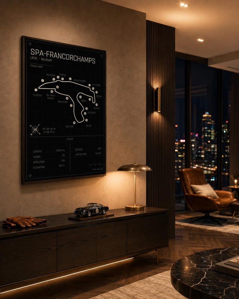 Pode incluir: Um poster preto emoldurado do mapa da pista de Spa-Francorchamps com linhas e texto brancos. Um carro modelo est&aacute; em um arm&aacute;rio de madeira escura, ao lado de uma l&acirc;mpada dourada. O quarto tem um design moderno com vista para a cidade.