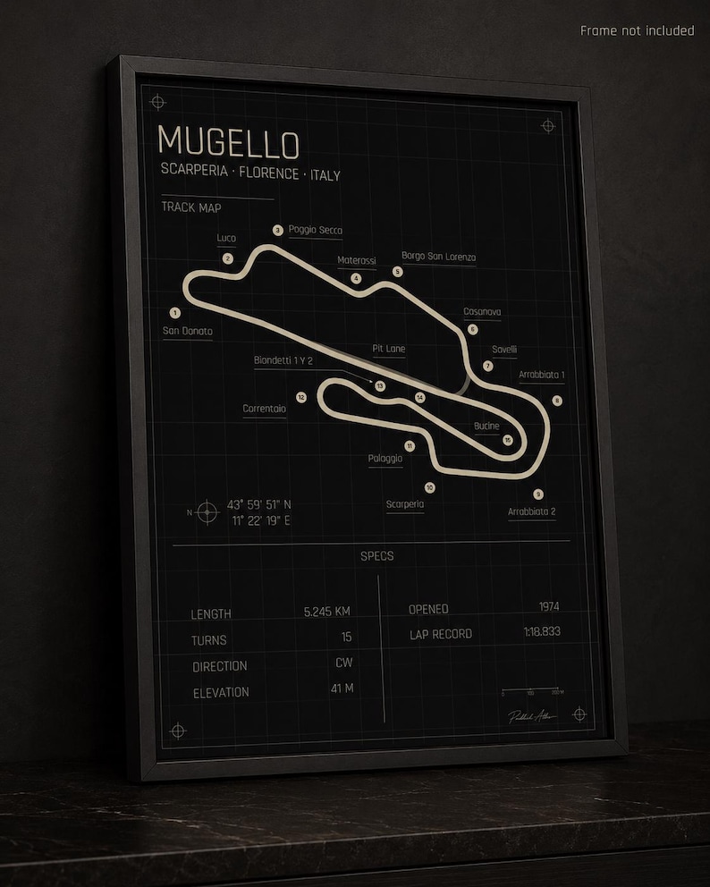 May include: Black framed print of the Mugello race track in Italy. The track map is in a light beige color against a dark background. The print includes track details such as length, turns, and elevation.
