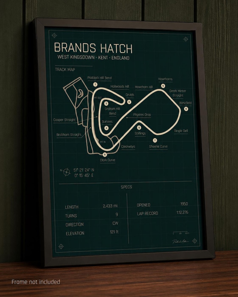 May include: Framed Brands Hatch track map print. The dark green print features a white track layout with labels for turns and straights. Includes track specs: 2.433 miles, 9 turns, and 121 ft elevation. The text "Frame not included" is at the bottom.
