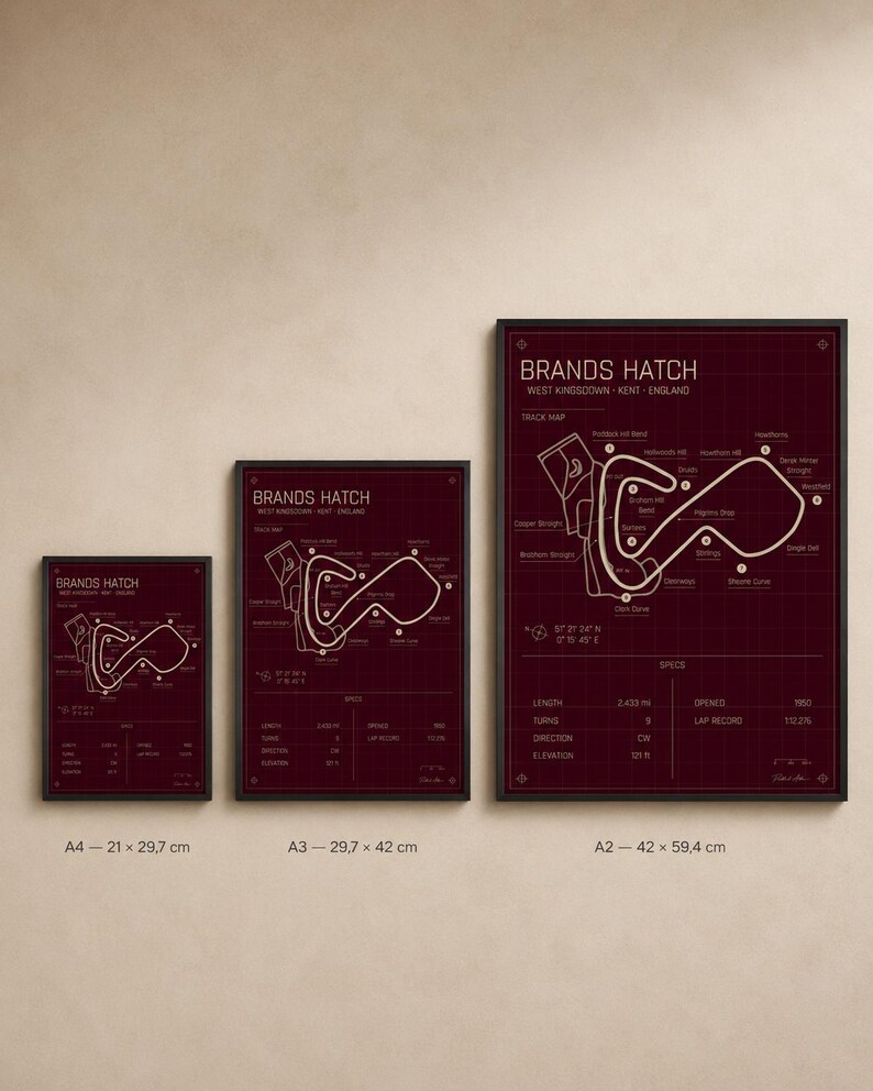 May include: Three framed prints of the Brands Hatch race track map in varying sizes. The prints feature a burgundy background with a white track layout and text. Sizes include A4 (8.3 x 11.7 inches), A3 (11.7 x 16.5 inches), and A2 (16.5 x 23.4 inches).
