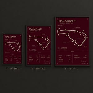 May include: Three framed prints of the Road Atlanta race track map in varying sizes. The prints feature a burgundy background with a white track outline and text. The sizes are A4 (21 x 29.7 cm), A3 (29.7 x 42 cm), and A2 (42 x 59.4 cm).
