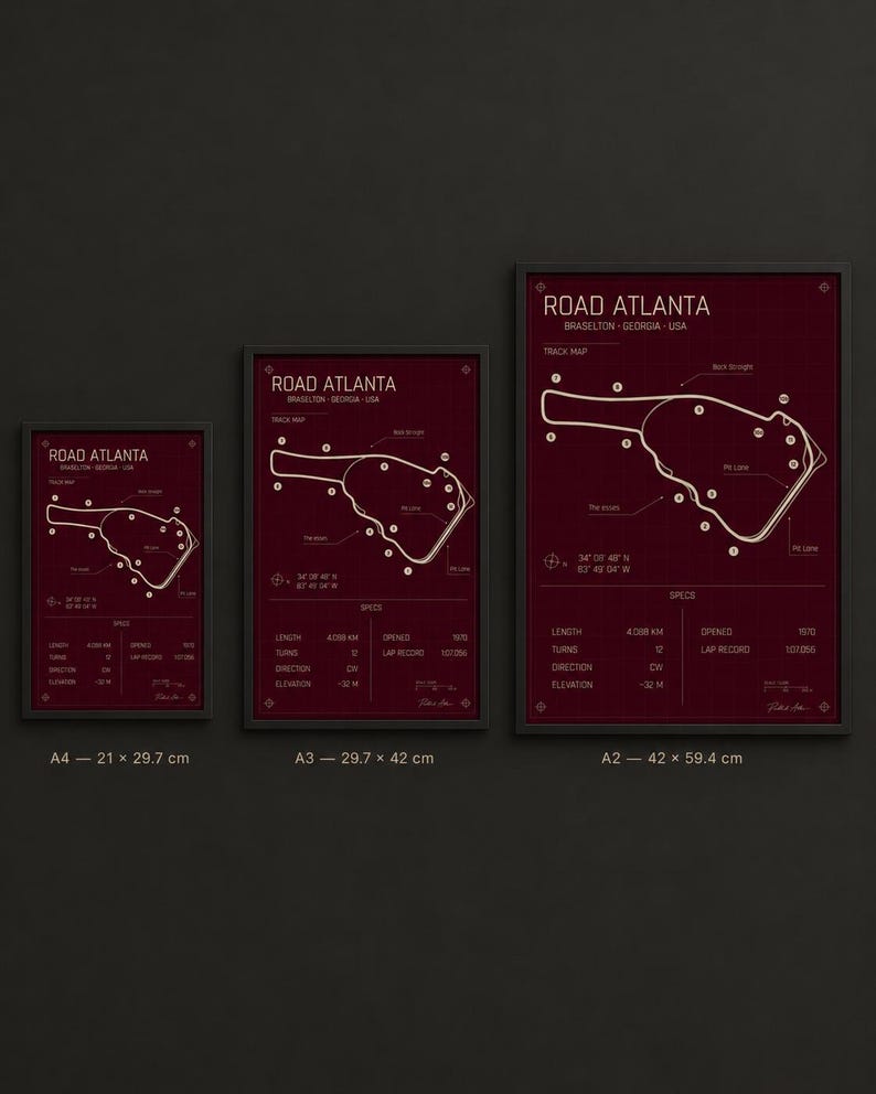 May include: Three framed prints of the Road Atlanta race track map in varying sizes. The prints feature a burgundy background with a white track outline and text. The sizes are A4 (21 x 29.7 cm), A3 (29.7 x 42 cm), and A2 (42 x 59.4 cm).