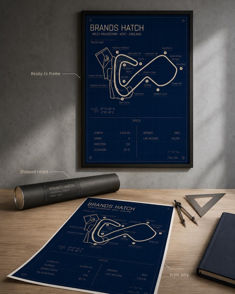 May include: A framed Brands Hatch track map poster in a black frame, with a rolled poster and print on a wooden surface. The poster is blue with white lines and text, including track details and specs. The text includes "Brands Hatch" and "West Kingsdown - Kent - England".