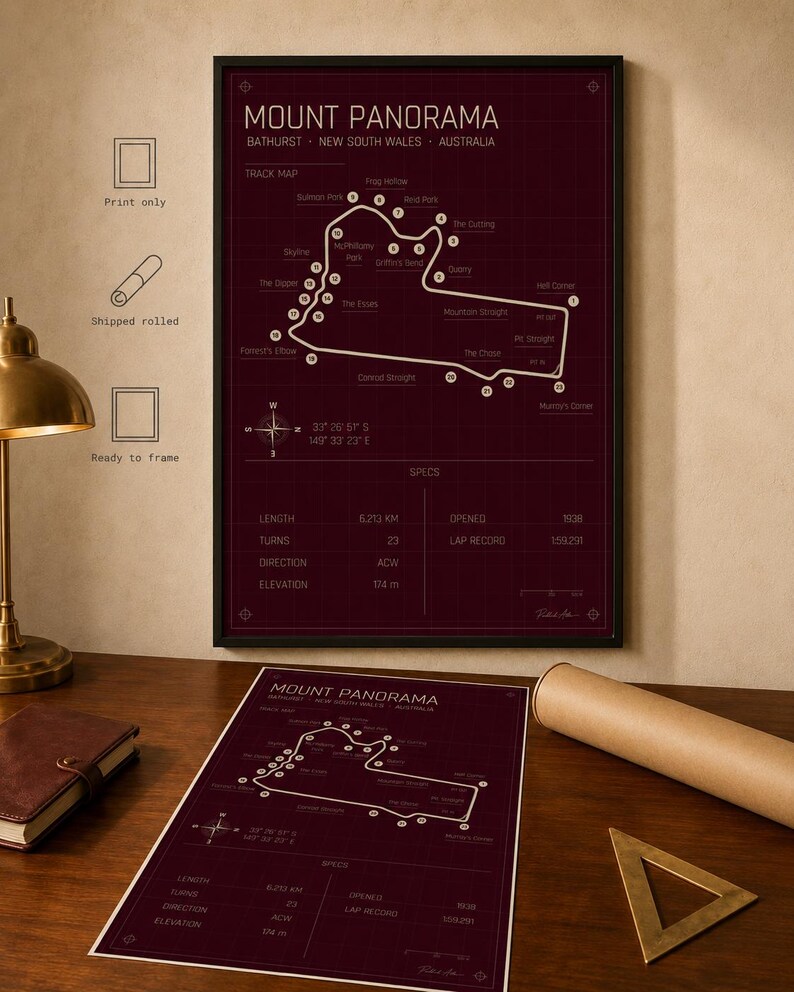 May include: Framed Mount Panorama race track map print in burgundy with white detailing. The print includes track specs, coordinates, and a compass rose. A rolled print and a ready-to-frame option are also shown.
