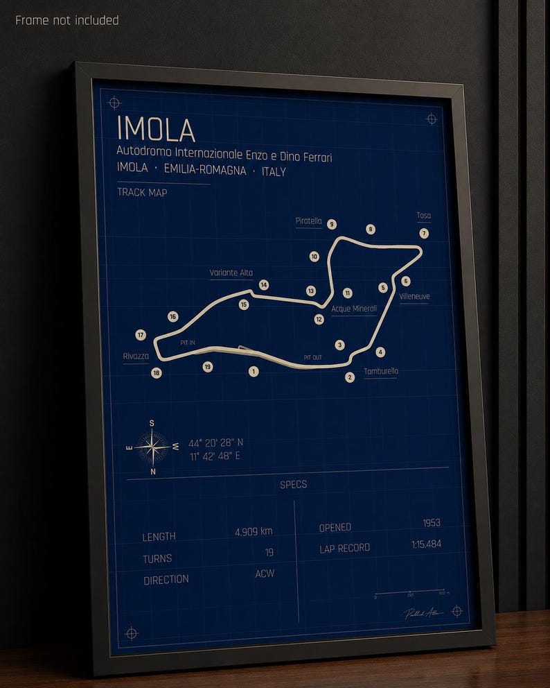 May include: Framed print of the Imola race track map, featuring the Autodromo Internazionale Enzo e Dino Ferrari in Italy. The track layout is white on a dark blue background, with labeled turns and specs including the 4.909 km length and 19 turns.