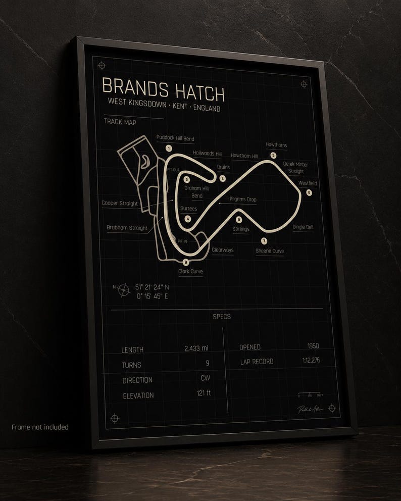 May include: Black framed Brands Hatch track map poster. The track map is in a light beige color, with the track layout and names of the turns. The poster includes specs such as length, turns, direction, and elevation. The text "Frame not included" is at the bottom.