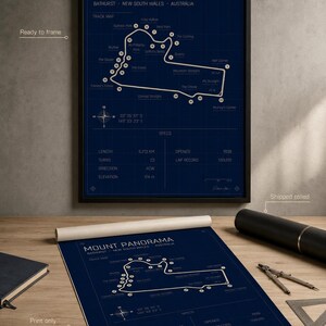 May include: A framed Mount Panorama race track map print in navy blue, with white lines and text. The print includes track details, specs, and the text "Mount Panorama Bathurst New South Wales Australia". A rolled print of the same map is also shown.