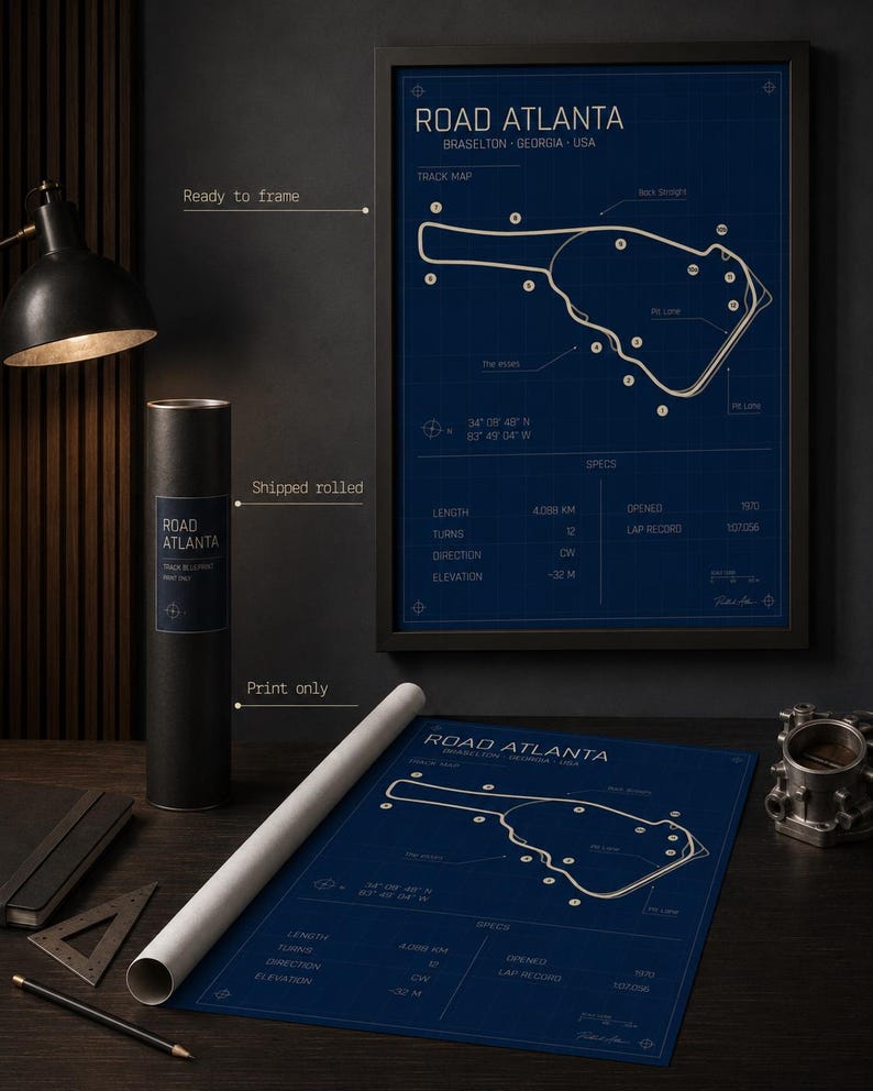 May include: A blueprint-style print of Road Atlanta, Braselton, Georgia, USA, with track map details. The print is available framed or rolled, with specifications including length, turns, and elevation. The print is ready to frame.