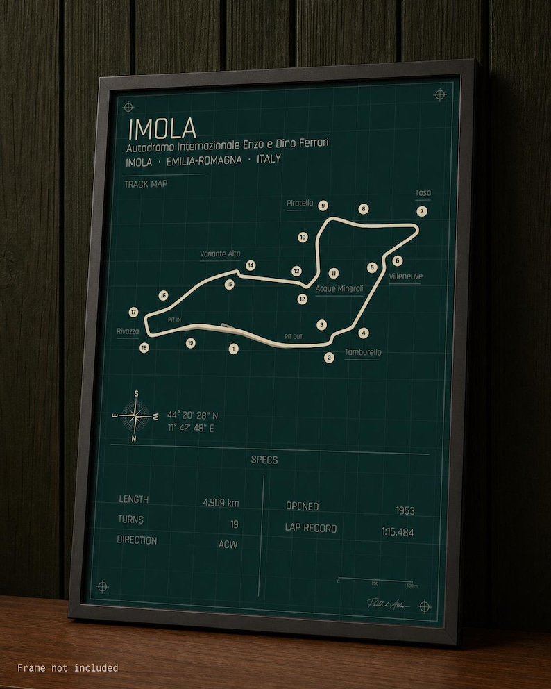 May include: Framed print of the Imola race track, Autodromo Enzo e Dino Ferrari, in Italy. The track map is white on a dark teal background, with labeled turns and specs including a length of 4.909 km. The frame is black.