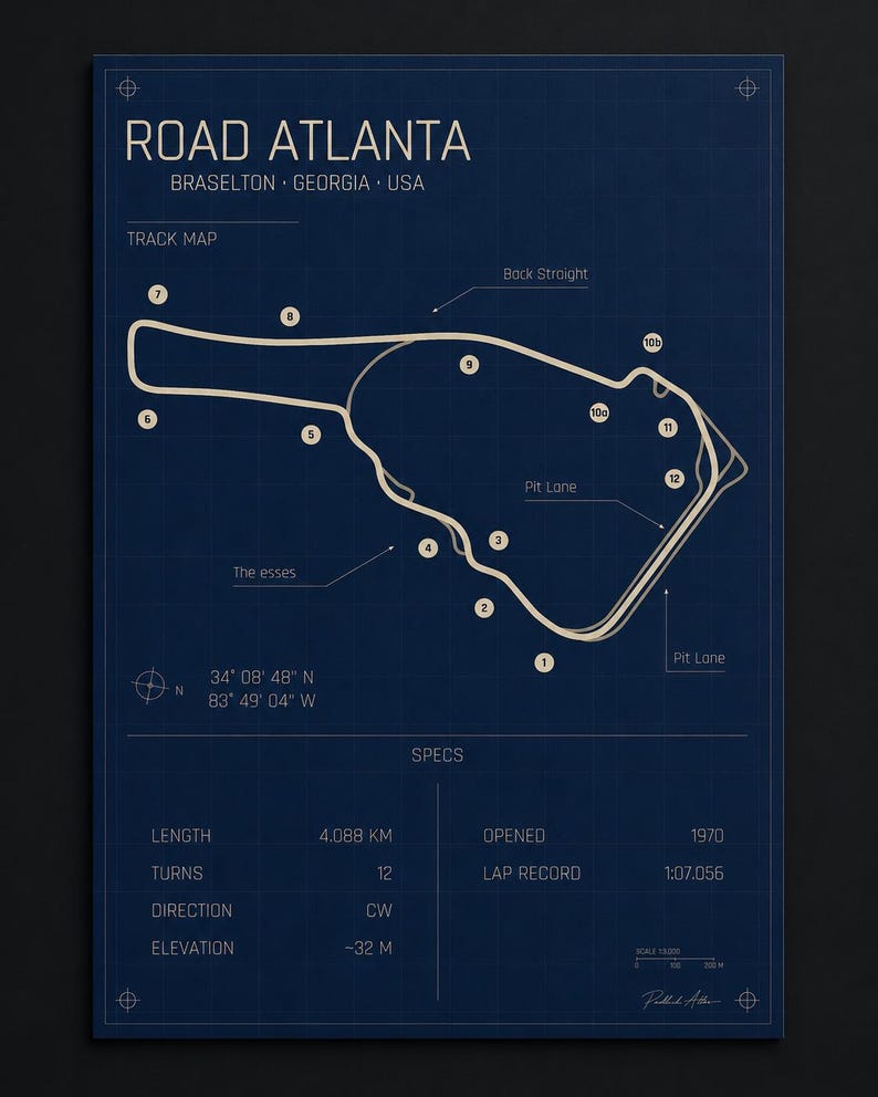 May include: A blueprint-style poster of the Road Atlanta racetrack in Braselton, Georgia, USA. The track map is in white against a dark blue background. Includes track specs: 4.088 km length, 12 turns, and opened in 1970. Features the text "Road Atlanta".