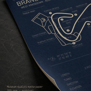 May include: A navy blue print of the Brands Hatch race track in West Kingsdown, Kent, England. The track map is in white, with labeled turns and straights. The print includes the text "BRANDS HATCH" and "TRACK MAP". The paper is museum-quality matte.