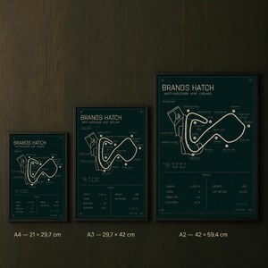 May include: Three framed prints of the Brands Hatch race track in West Kingsdown, Kent, England. The prints are in A4 (8.3 x 11.7 inches), A3 (11.7 x 16.5 inches), and A2 (16.5 x 23.4 inches) sizes, with a dark teal background and white track details.