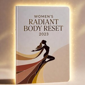 May include: A hardcover book titled "WOMEN'S RADIANT BODY RESET 2023". The cover features a silhouette of a woman with flowing hair and a dress in shades of brown and gold. The background is a soft beige with a glowing effect.
