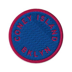 May include: A round embroidered patch with a blue center and a red border. The words "CONEY ISLAND" and "BKLYN" are embroidered in red around the blue center.