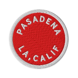 May include: A circular embroidered patch with a bright red center and a white border. The text PASADENA is arched across the top, and the text LA, CALIF is arched across the bottom in white, capitalized, sans-serif embroidered lettering.