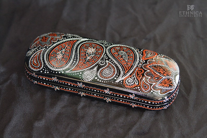 Eyeglass case for small glasses, hand-painted with red and silver paisley design. View from the side, to show the design on sides