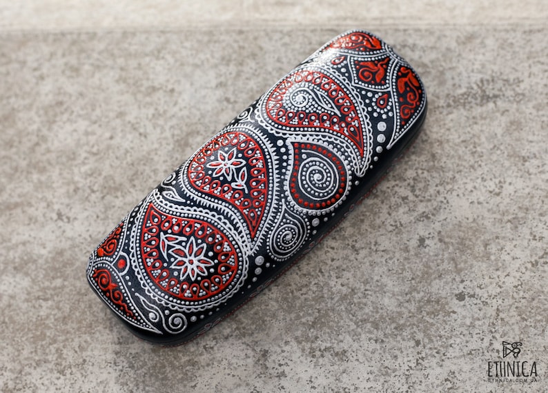 Eyeglass case for reading glasses, hand-painted with red and silver paisley design. View from the top