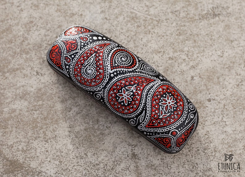 Eyeglass case for reading glasses, hand-painted with red and silver paisley design. View from the top