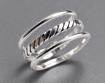 May include: A set of three silver-toned rings stacked together. The top ring is a smooth, thin band, the middle ring features a twisted rope-like texture, and the bottom ring is a plain, polished band. The text TheHeavenOfCraft is visible.