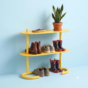 May include: A yellow two-tier shoe rack with rounded shelves and a tubular frame. The top shelf holds a potted snake plant and a small tray. The shelves display brown leather boots, grey trainers, and patterned red and blue rain boots.