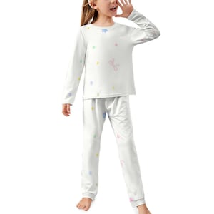May include: White pajama set with a long-sleeved top and pants. The set is decorated with small, colorful flower and bow patterns. The pajamas are made of a soft, comfortable material, perfect for a relaxing night's sleep.
