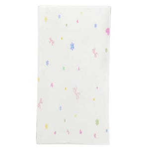 May include: A rectangular white baby blanket with a repeating pattern of pastel-colored bows, hearts, flowers, and dots. The bows are pink, the hearts are pink, the flowers are blue and green, and the dots are yellow.