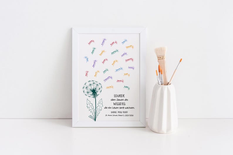 May include: A white framed print featuring a green dandelion illustration with seeds floating upwards as colourful names. The text reads: LEHRER s&auml;en Samen des WISSENS, die ein Leben lang wachsen. DANKE FRAU KREH! St. Anne Schule, Klasse 3, 2023/2024.
