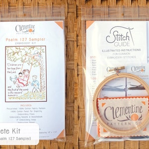 May include: A complete embroidery kit for a Psalm 127 sampler. The kit includes a pre-printed cotton fabric pattern, embroidery floss, a needle and needlebook, and a 4-inch embroidery hoop. The pattern features a colorful illustration of children on a swing with the text "Children are a heritage from the Lord and the fruit of the womb is His reward."