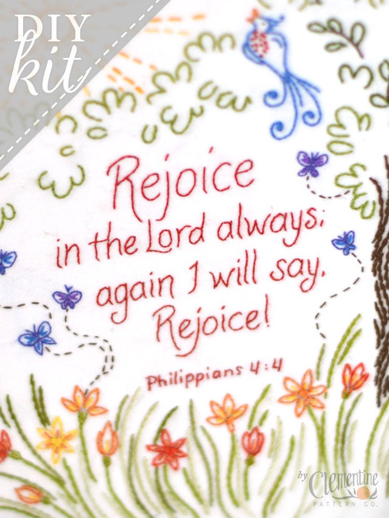 May include: A white embroidery kit with a floral design and the text "Rejoice in the Lord always. Again I will say. Rejoice! Philippians 4:4" in red thread. The kit is by Clementine Pattern Co.