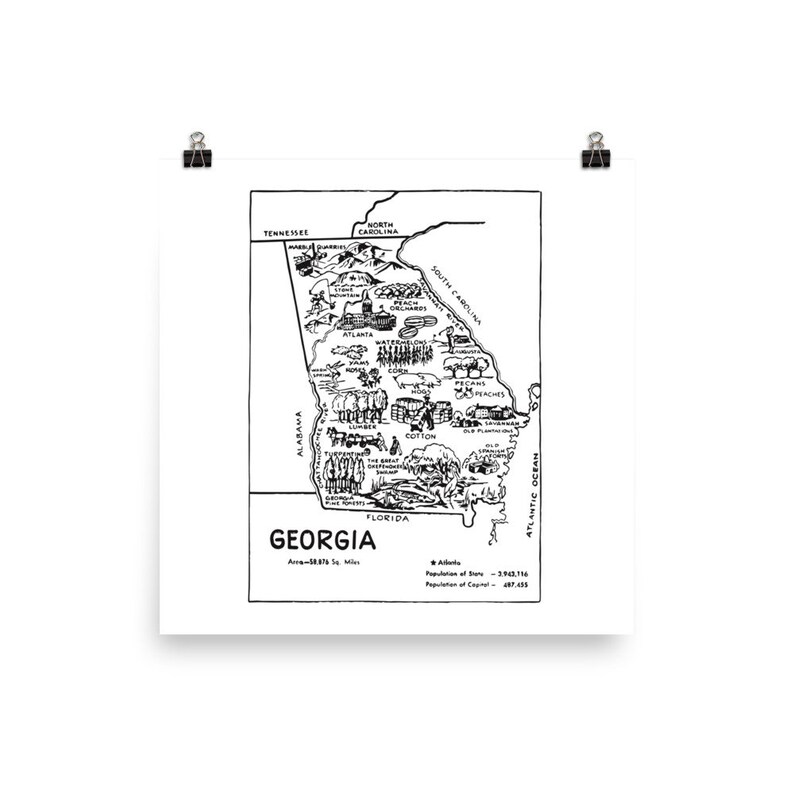 May include: A black and white line drawing of the state of Georgia, with various icons representing the state's features, such as peaches, cotton, and the state capitol building. The text "GEORGIA" is printed below the map, along with the state's area and population information.