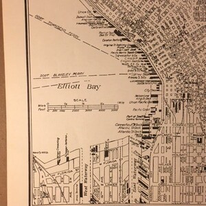 May include: A black and white map of central Seattle, Washington, showing the city's waterfront and surrounding areas. The map includes the text "Elliott Bay" and "Map of Central Seattle, the Chief City of Washington and Industrial Center of the Pacific Northwest. Over 100 Steamship Lines Connecting the City with Asiatic, European and South American Ports."