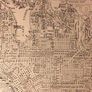 May include: A black and white map of a city with streets, buildings, and landmarks. The map includes the names of streets, parks, and bodies of water. The map is labeled "Union" and "Lake".
