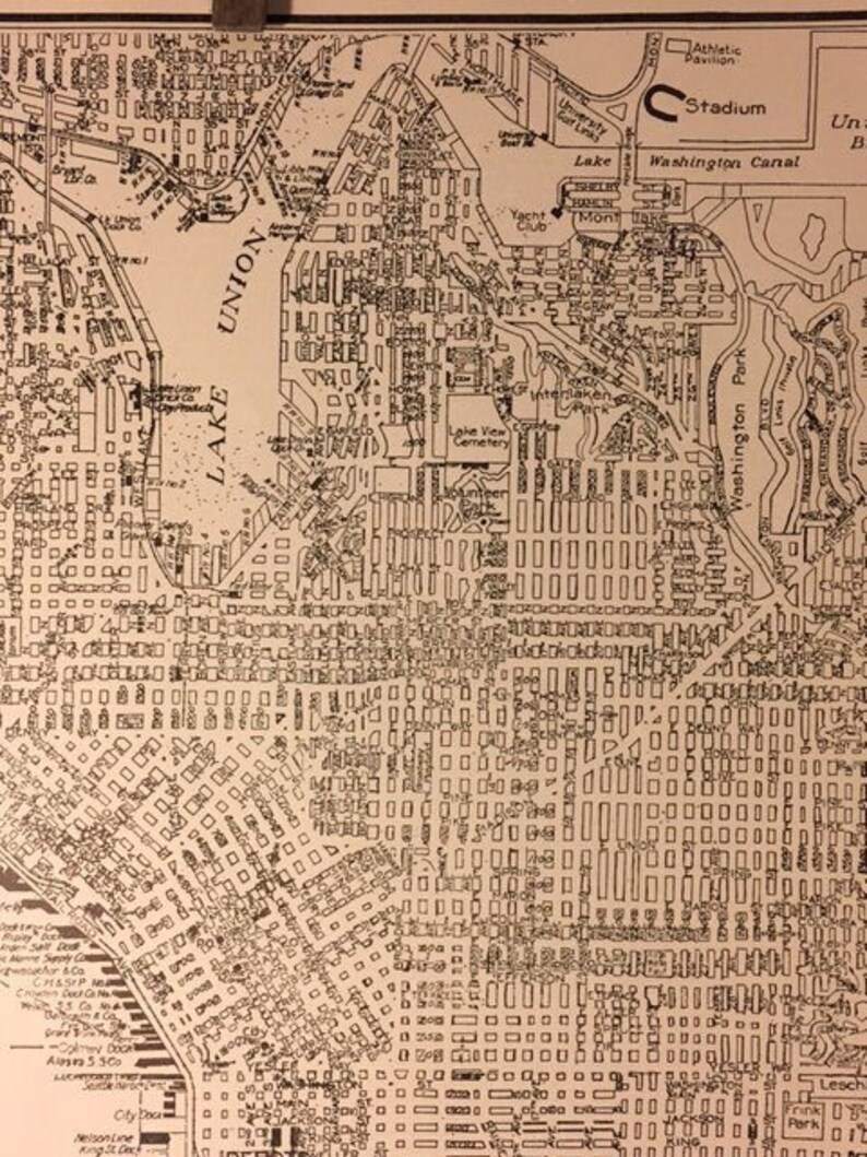 May include: A black and white map of a city with streets, buildings, and landmarks. The map includes the names of streets, parks, and bodies of water. The map is labeled "Union" and "Lake".