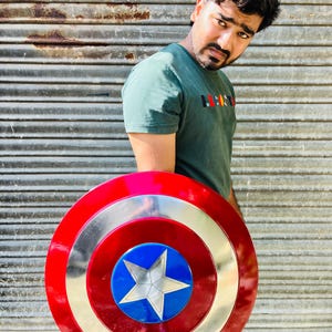 Pu&ograve; includere: Uno scudo di Captain America rosso, bianco e argento, con un centro blu e una stella argentata. Lo scudo ha un design circolare con anelli concentrici colorati. &Egrave; un oggetto di scena o da collezione.