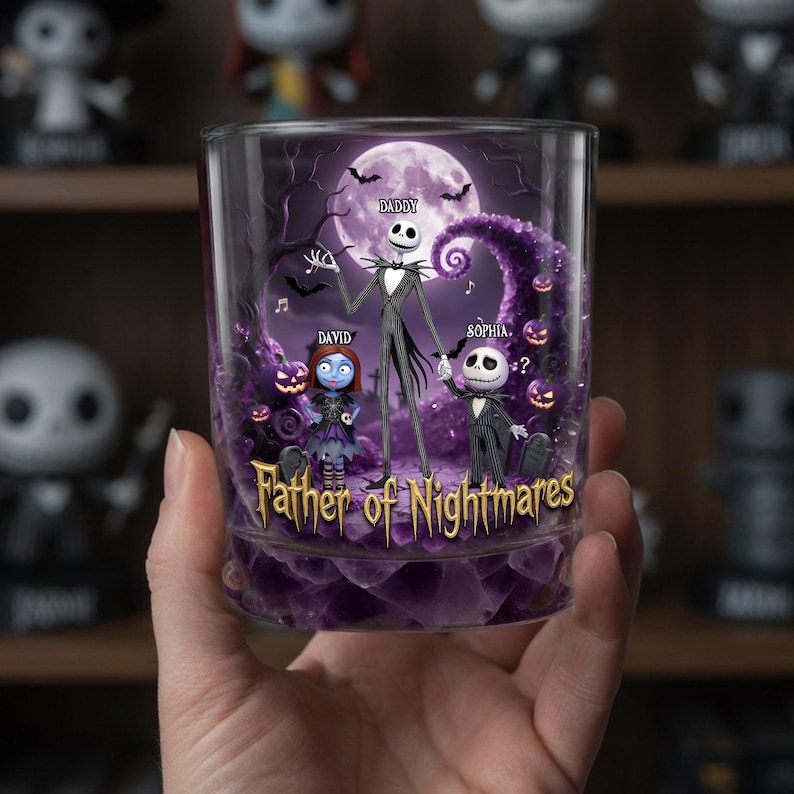 May include: A clear glass tumbler featuring a design with Jack Skellington, Sally, and a child character, with the text "Father of Nightmares." The background includes a full moon, bats, and purple accents. The word "Daddy" is written above Jack's head.