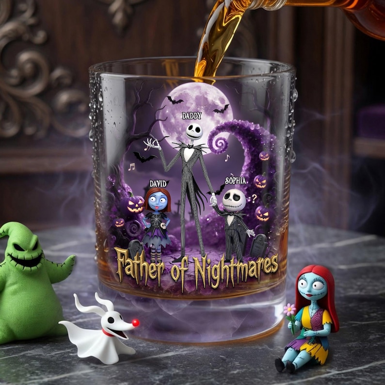 May include: A clear glass tumbler with a spooky design featuring Jack Skellington and other characters from The Nightmare Before Christmas. The words "Father of Nightmares" are printed on the glass. A liquid is being poured into the glass.