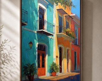 May include: A framed oil painting depicting a street scene with vibrant turquoise, yellow, and orange buildings. The architecture features balconies with black railings, arched doorways, and potted green plants. A wall-mounted lantern is visible.