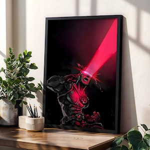 May include: A framed vertical art print featuring a comic book character with a visor emitting a bright red laser beam from their eyes. The character is depicted in a dark, muscular suit with red highlights against a deep black background.