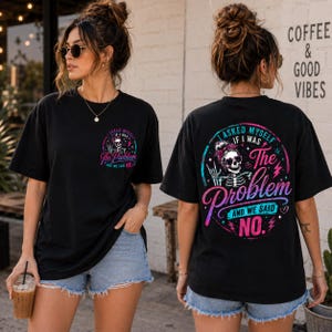 May include: A black short-sleeve t-shirt featuring a graphic print of a skeleton wearing a bandana and sunglasses. The front has a small chest logo, while the back displays a large version of the same design with the text I ASKED MYSELF IF I WAS THE PROBLEM AND WE SAID NO.