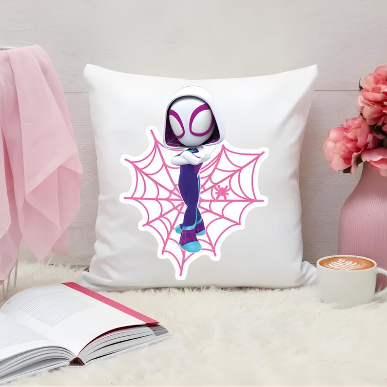 May include: A square white throw pillow featuring a centered graphic of a stylized character in a white, purple, and blue hooded suit standing in front of a large pink spiderweb design. The character has a white mask with pink eye outlines.