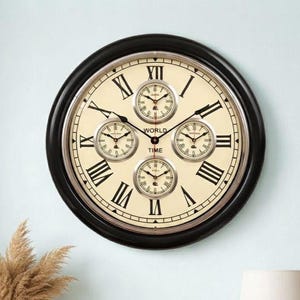 May include: A round wall clock with a black frame and a cream-colored face featuring large black Roman numerals. The center displays the text WORLD TIME and four smaller circular clock dials, each with its own set of hands and markings.
